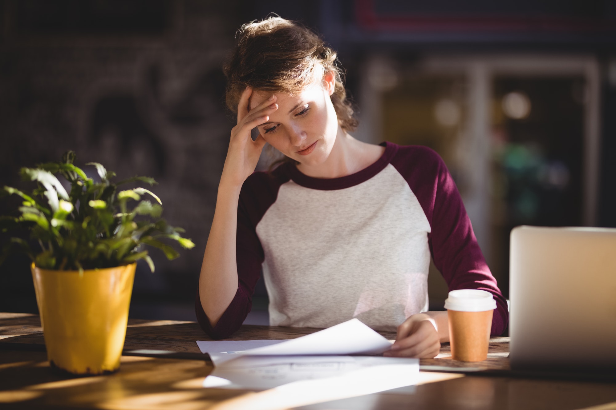 Troubled young female reading IRS Letter