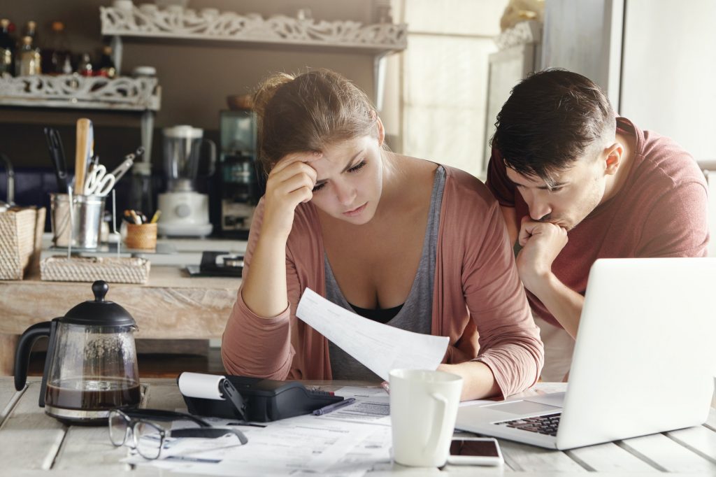 Young married couple facing financial problem during economic crisis. Frustrated woman and unhappy m